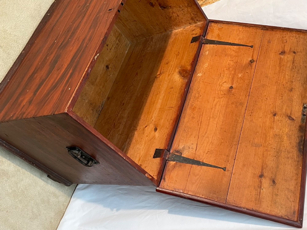 A nineteenth-century rectangular pine blanket box with a reddish-brown painted finish, hinged lid, keyhole, and bracket feet. View III
