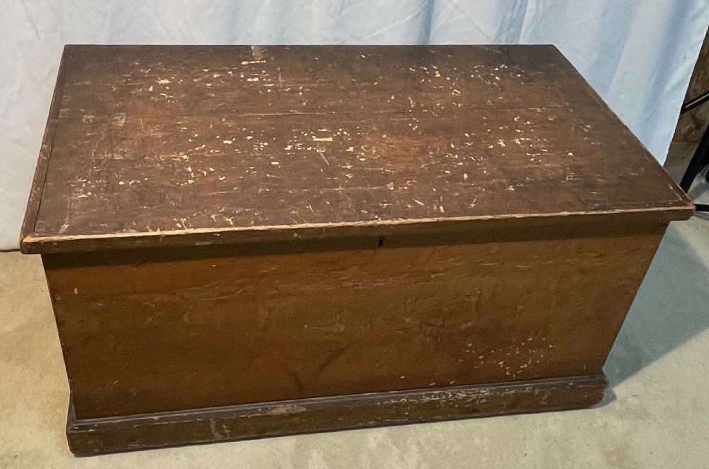 An open antique pine blanket box with a faux-grain painted exterior, exposed internal timber, and iron strap hinges. View VIII