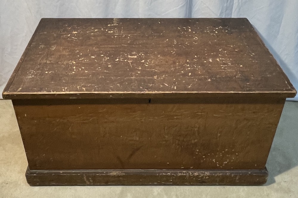 An open antique pine blanket box with a faux-grain painted exterior, exposed internal timber, and iron strap hinges. View IX