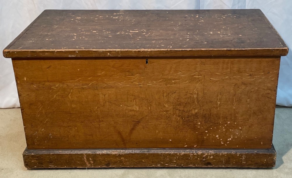 An open antique pine blanket box with a faux-grain painted exterior, exposed internal timber, and iron strap hinges. View X