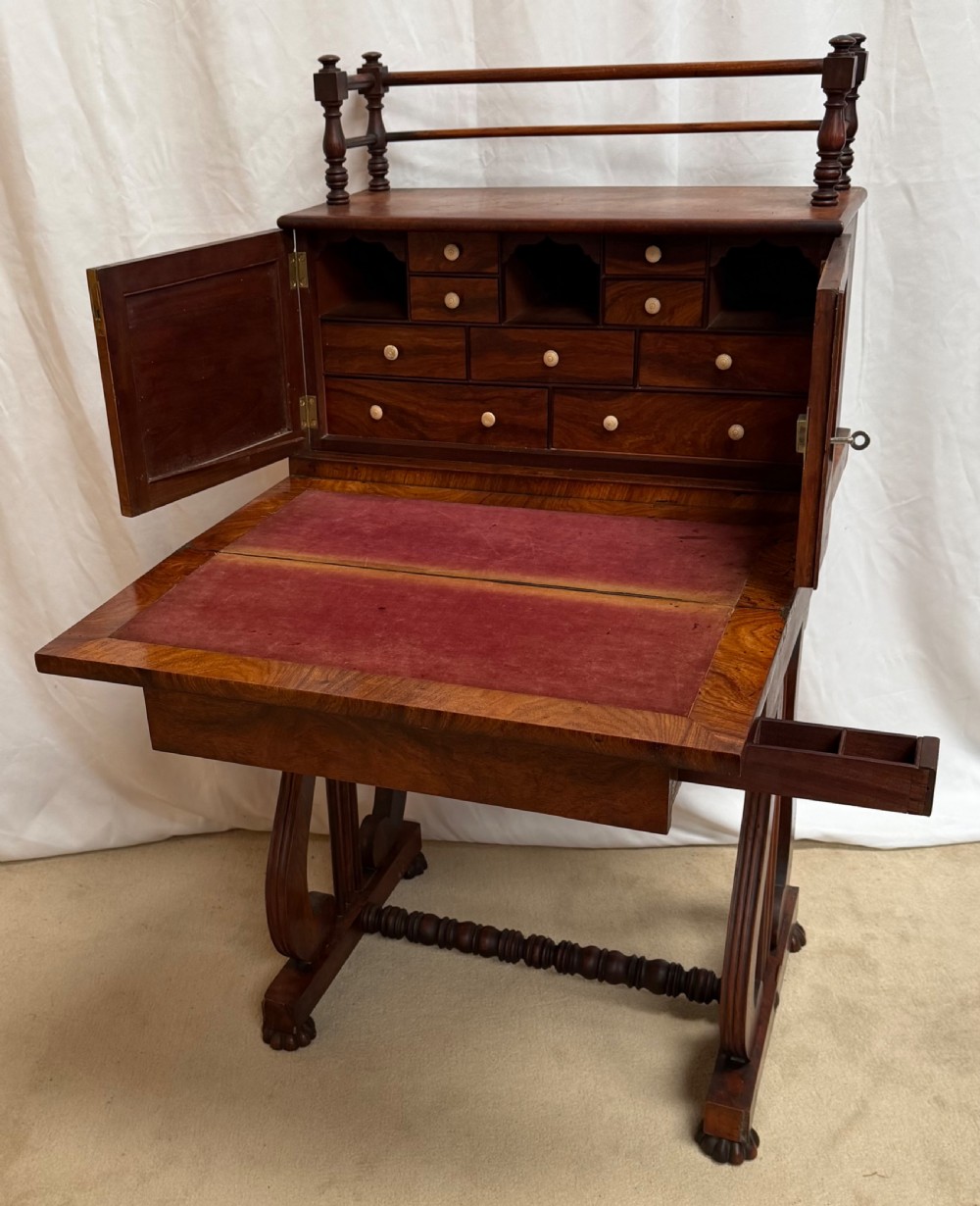 A dark mahogany Regency writing desk featuring twin lyre-shaped end supports, a fold-out leather-lined writing surface, and an upper cabinet with small fitted drawers. View II