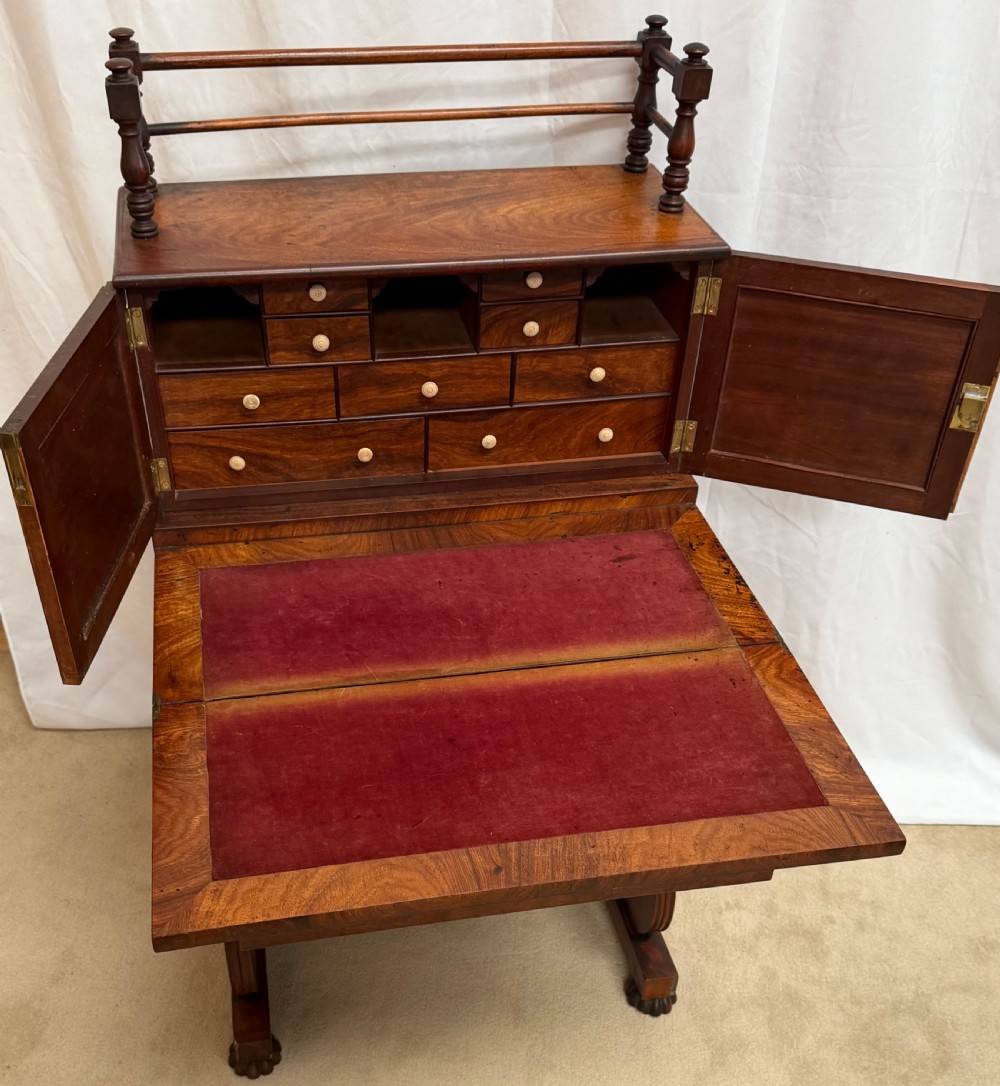 A dark mahogany Regency writing desk featuring twin lyre-shaped end supports, a fold-out leather-lined writing surface, and an upper cabinet with small fitted drawers. View VIII
