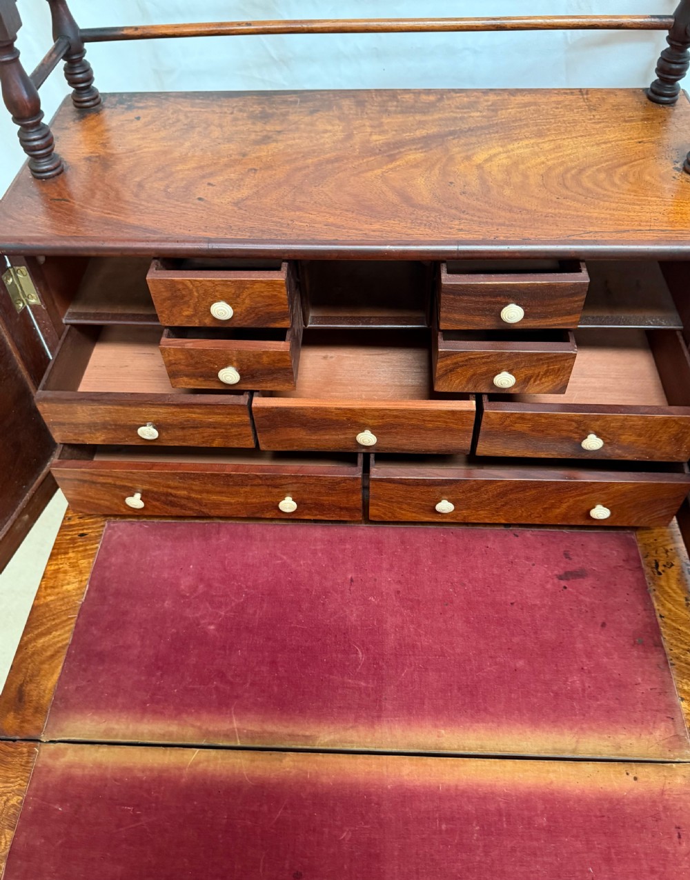 A dark mahogany Regency writing desk featuring twin lyre-shaped end supports, a fold-out leather-lined writing surface, and an upper cabinet with small fitted drawers. View IX