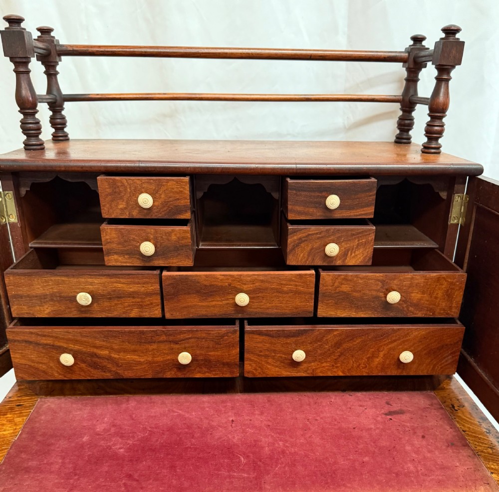 A dark mahogany Regency writing desk featuring twin lyre-shaped end supports, a fold-out leather-lined writing surface, and an upper cabinet with small fitted drawers. View X