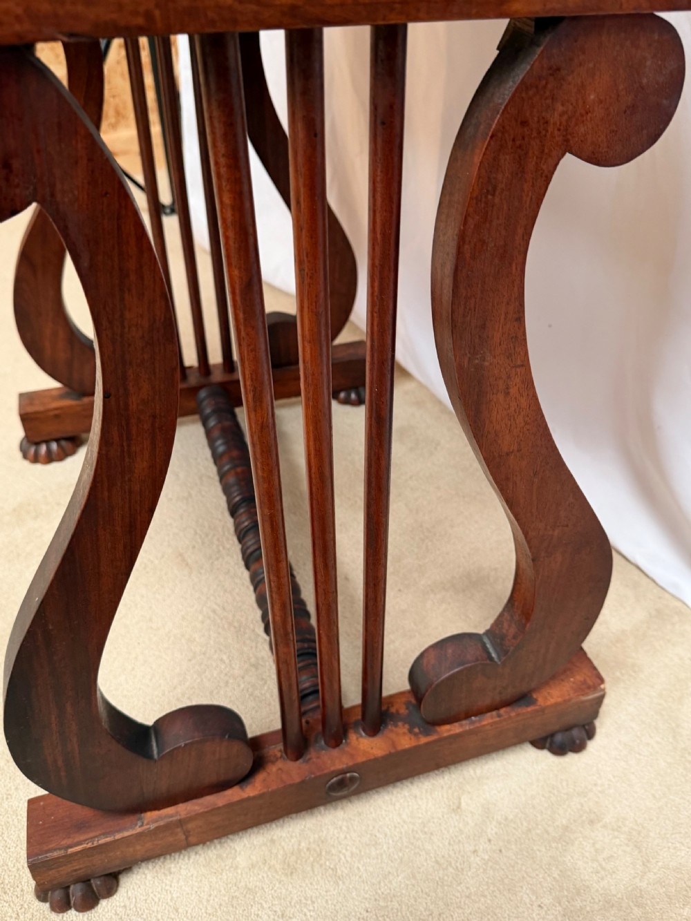 A dark mahogany Regency writing desk featuring twin lyre-shaped end supports, a fold-out leather-lined writing surface, and an upper cabinet with small fitted drawers. View XIV