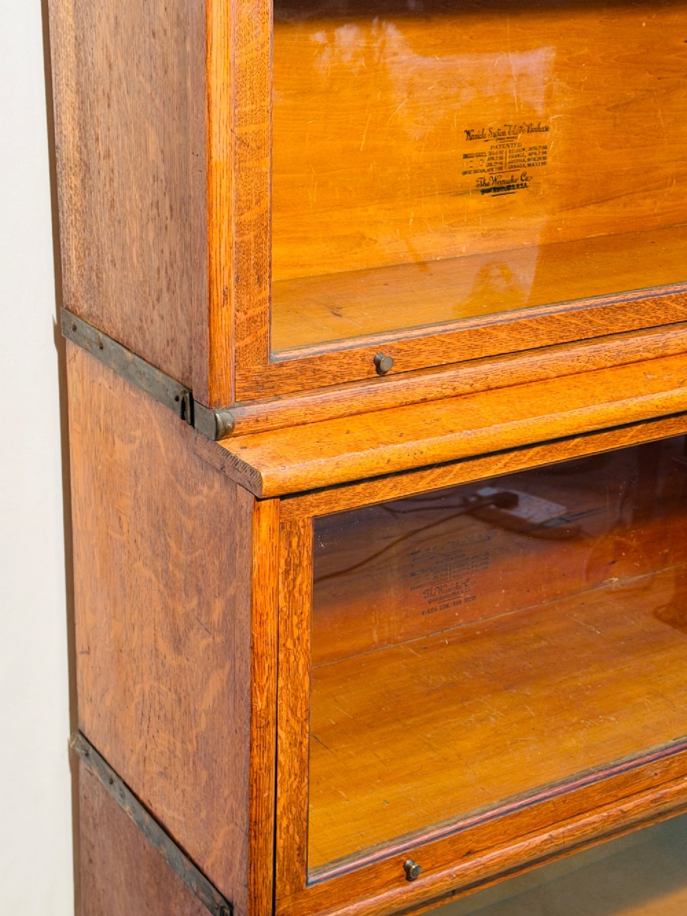 A six-piece antique oak modular barrister bookcase with four glass-fronted lifting doors and metal side straps. View VI