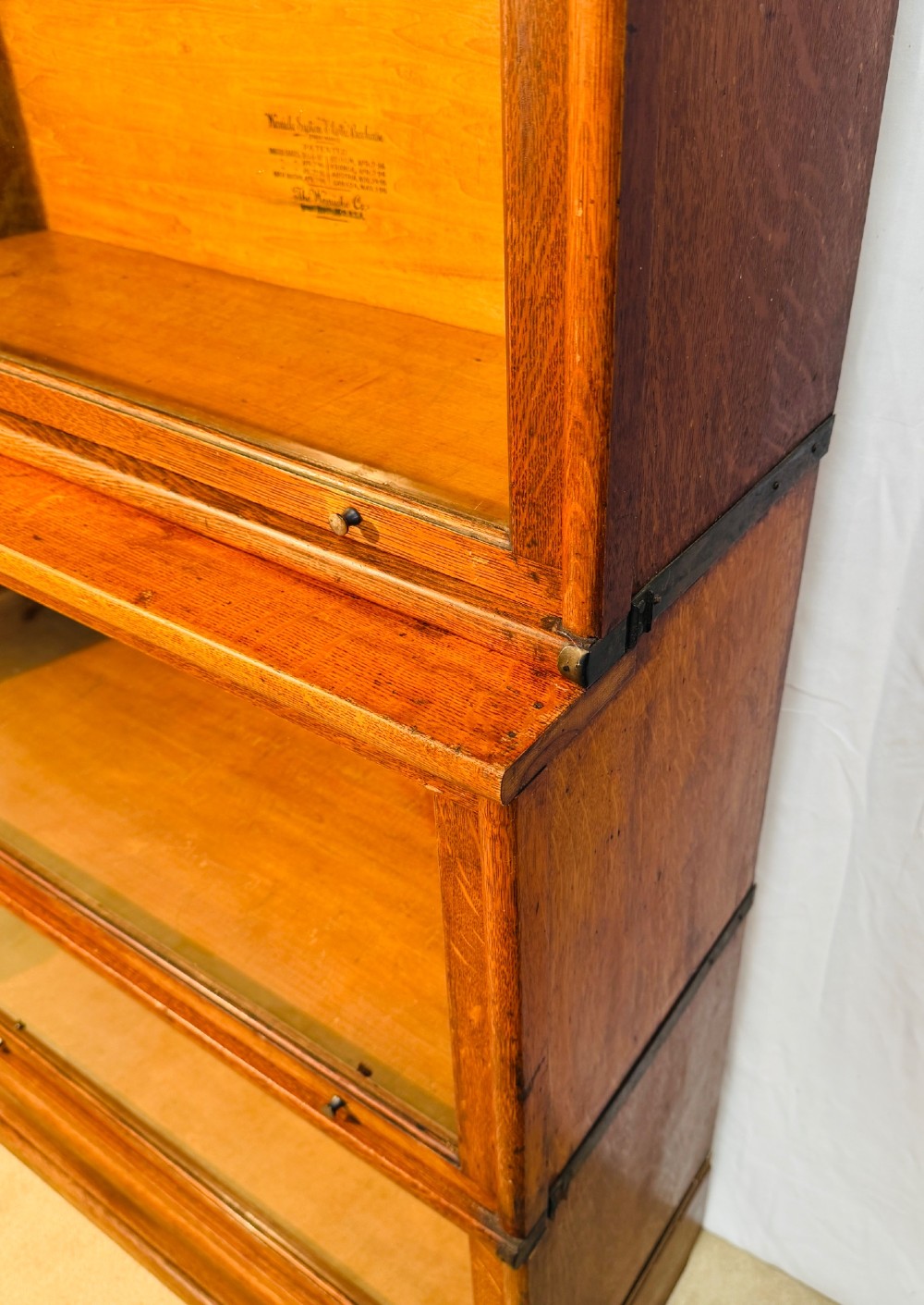 A six-piece antique oak modular barrister bookcase with four glass-fronted lifting doors and metal side straps. View VII