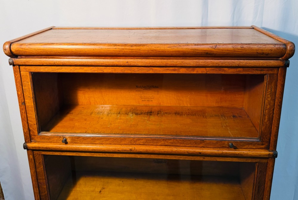 A six-piece antique oak modular barrister bookcase with four glass-fronted lifting doors and metal side straps. View VIII