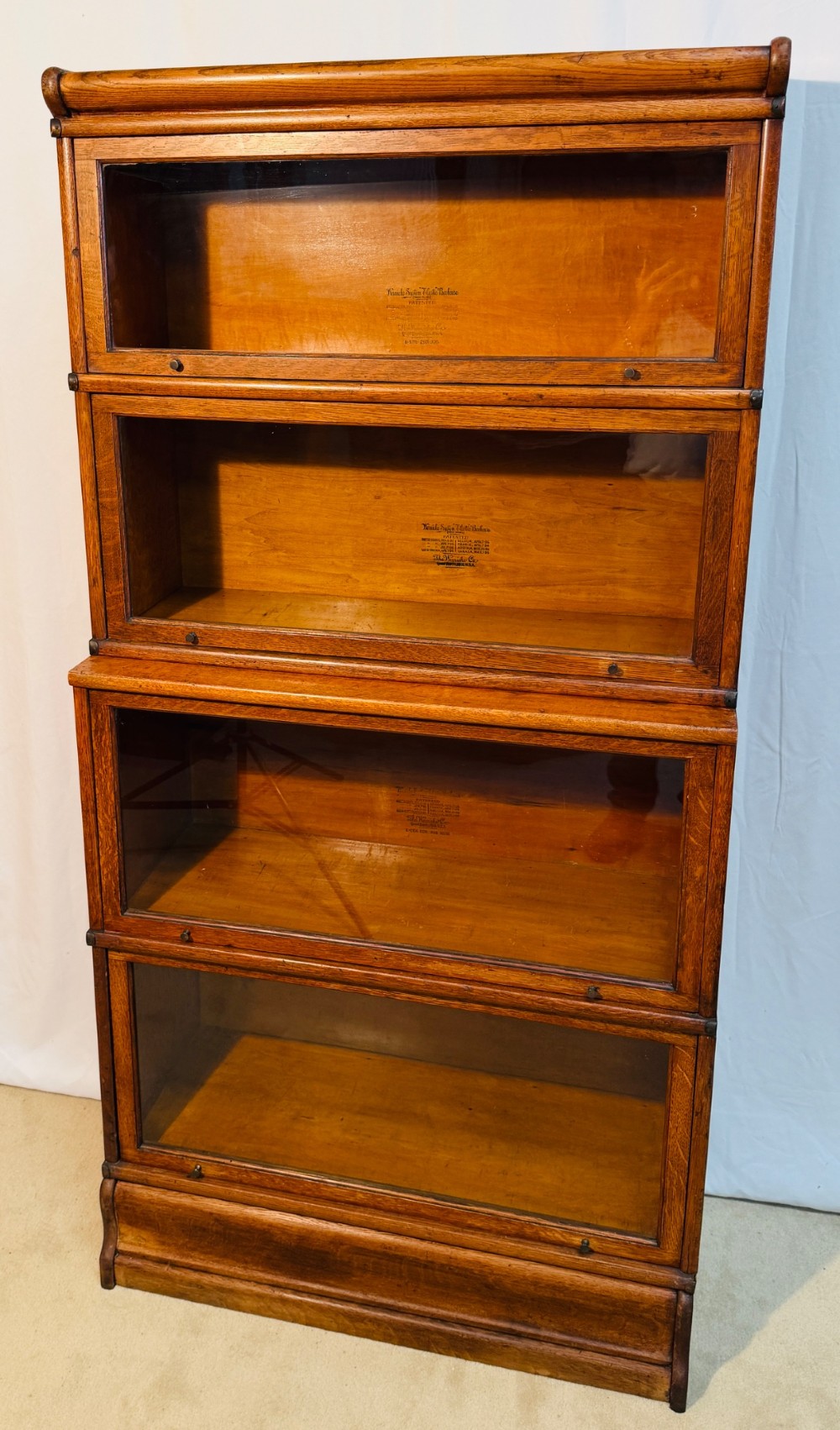 A six-piece antique oak modular barrister bookcase with four glass-fronted lifting doors and metal side straps. View IX