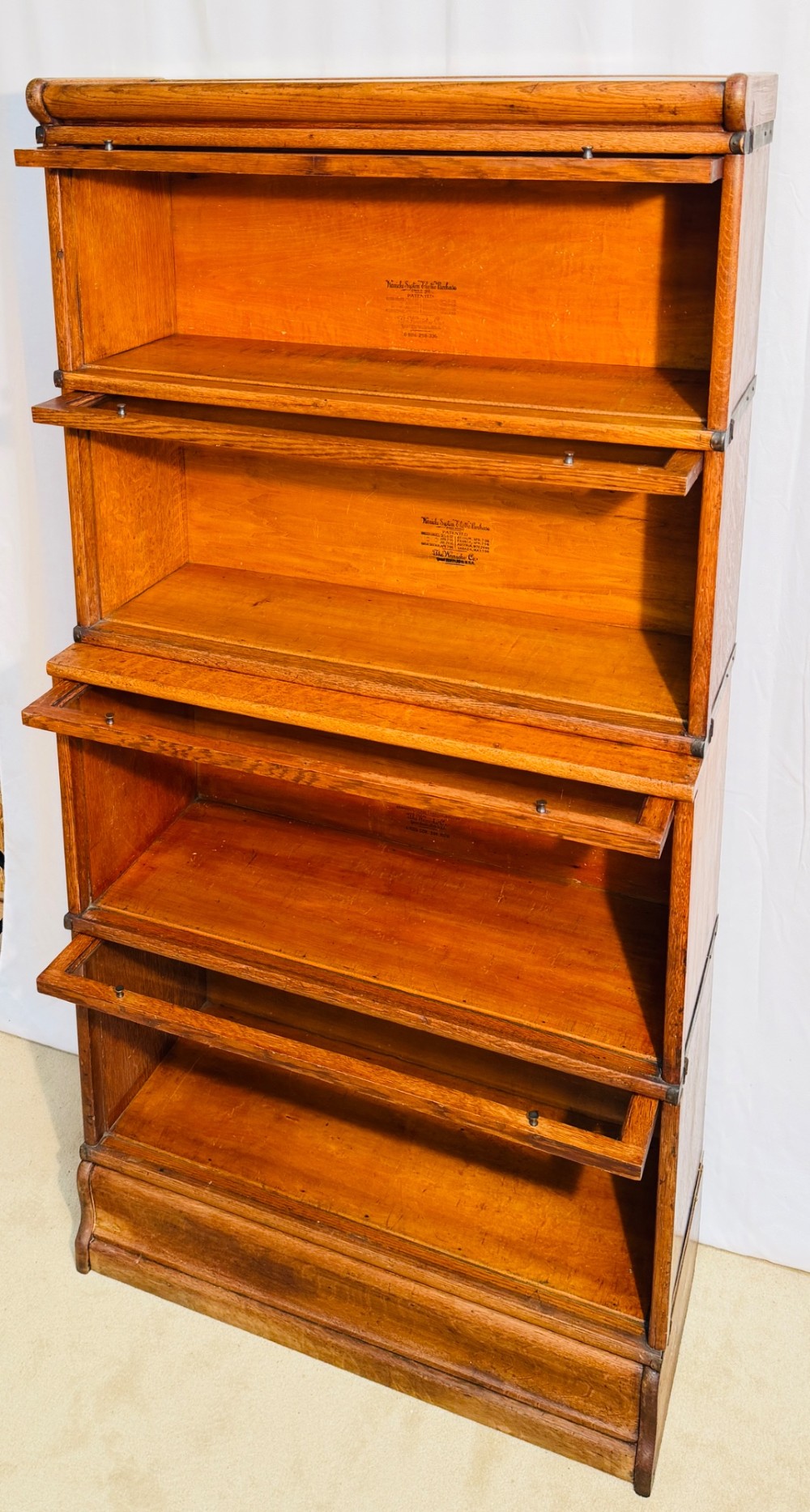 A six-piece antique oak modular barrister bookcase with four glass-fronted lifting doors and metal side straps. View XI