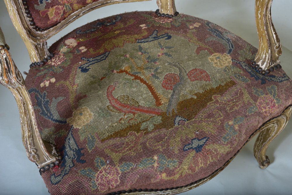 A pair of late 18th-century French painted wood fauteuil armchairs featuring curved cabriole legs and hand-stitched floral and figurative needlework upholstery. View III