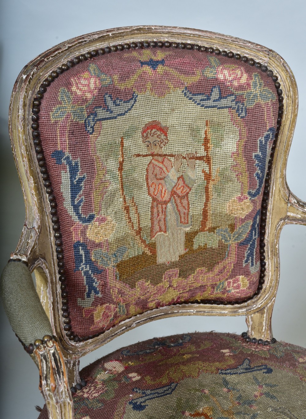 A pair of late 18th-century French painted wood fauteuil armchairs featuring curved cabriole legs and hand-stitched floral and figurative needlework upholstery. View VIII