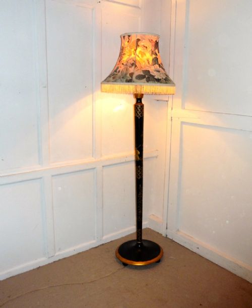 A Black Lacquer and Gold Standard Lamp