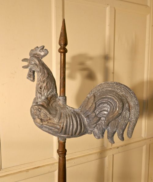 fig 1. Cockerel Weather Vane Mounted on a Tower Roof Finial