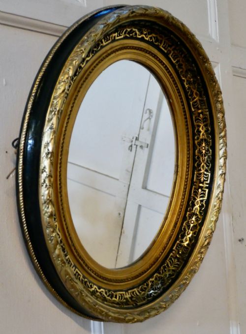 Superb Deep Oval Frame French Empire Gilt and Lacquer Wall Mirror