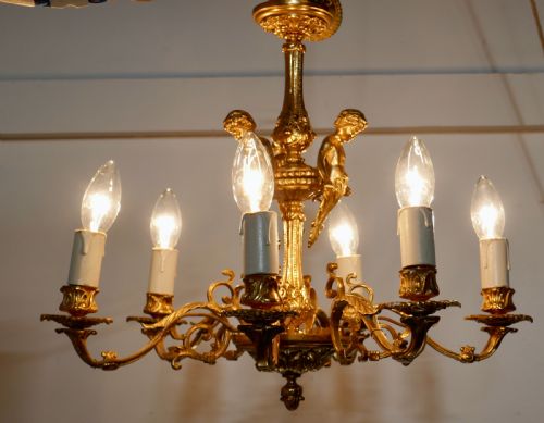 A French Gilded Brass 6 Branch Rococo Cherub Chandelier