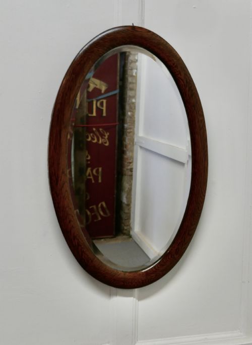A Large Edwardian Oak Oval Mirror
