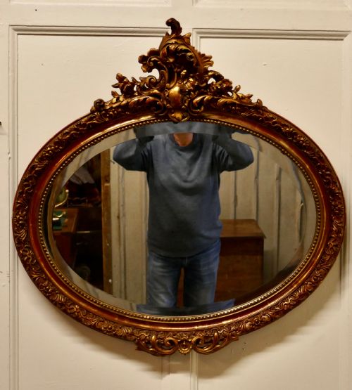 A Superb Late 19th Century Regency Style Oval Gilt Mirror