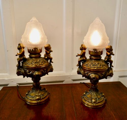 A Pair of  19th Century French Gilt Lamps in the Form of Cherubs or Putti