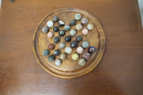 A Set of French Marbles on a Turned Solitaire Board