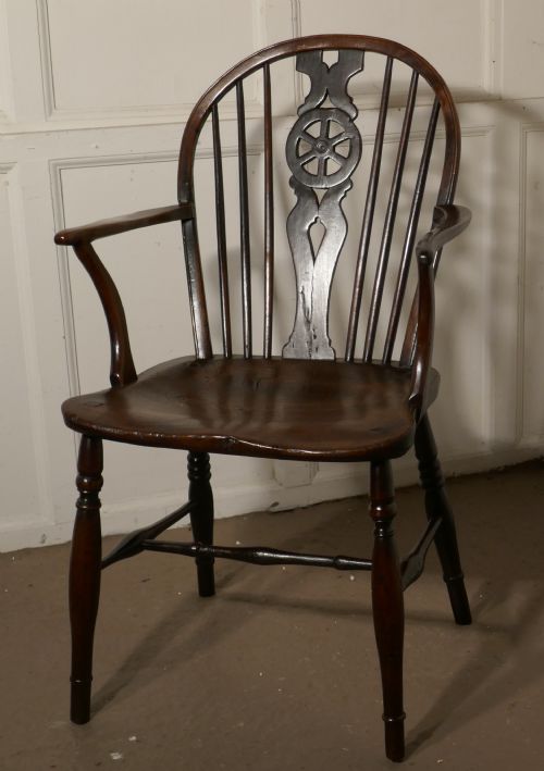 An Early 19th Elm Wheel Back Carver Chair