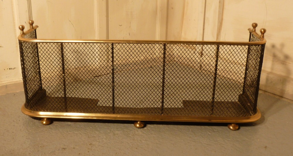 A Victorian Brass and Iron Club Fender
