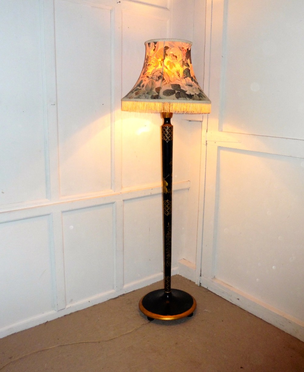 A Black Lacquer and Gold Standard Lamp