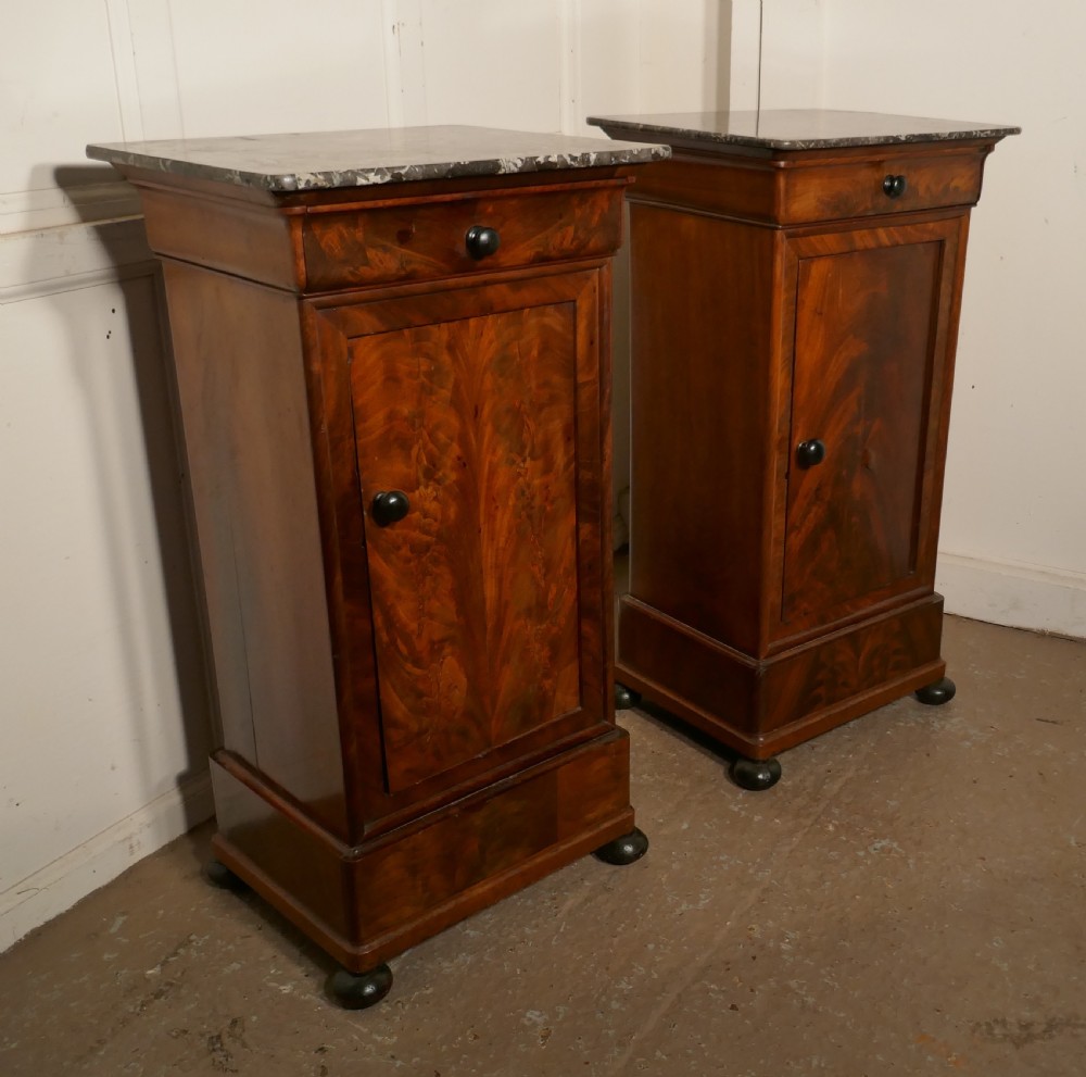 A Pair of Figured Mahogany Bedside Cupboards