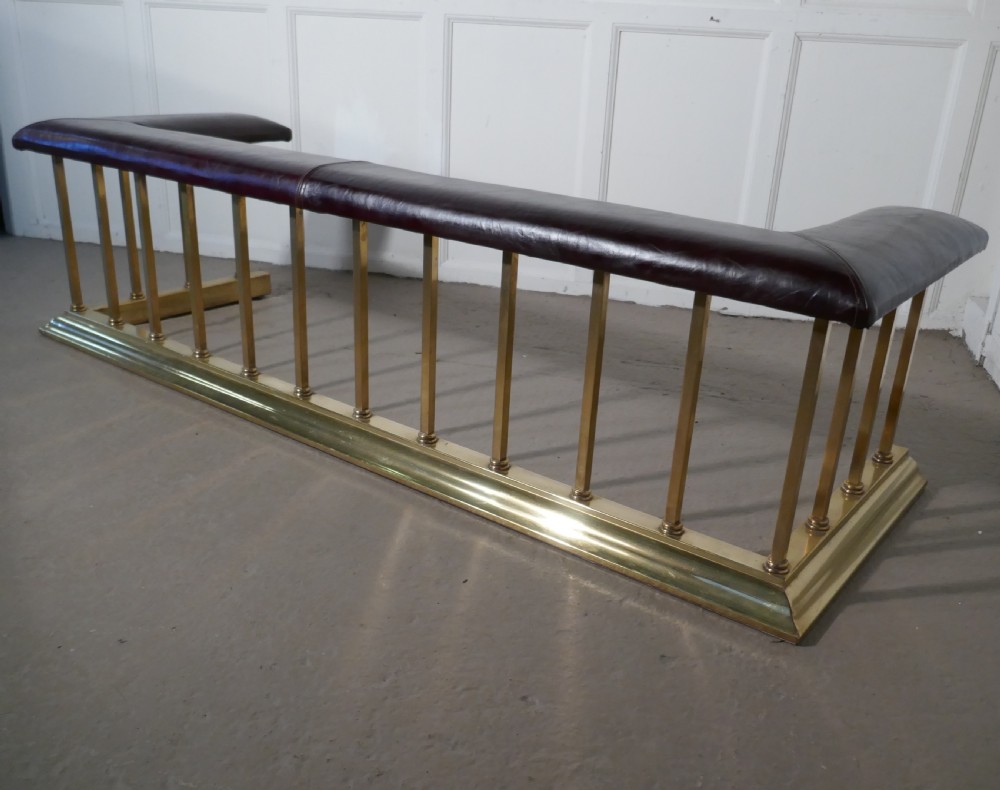 A Large Brass and Leather Club Fender View VII