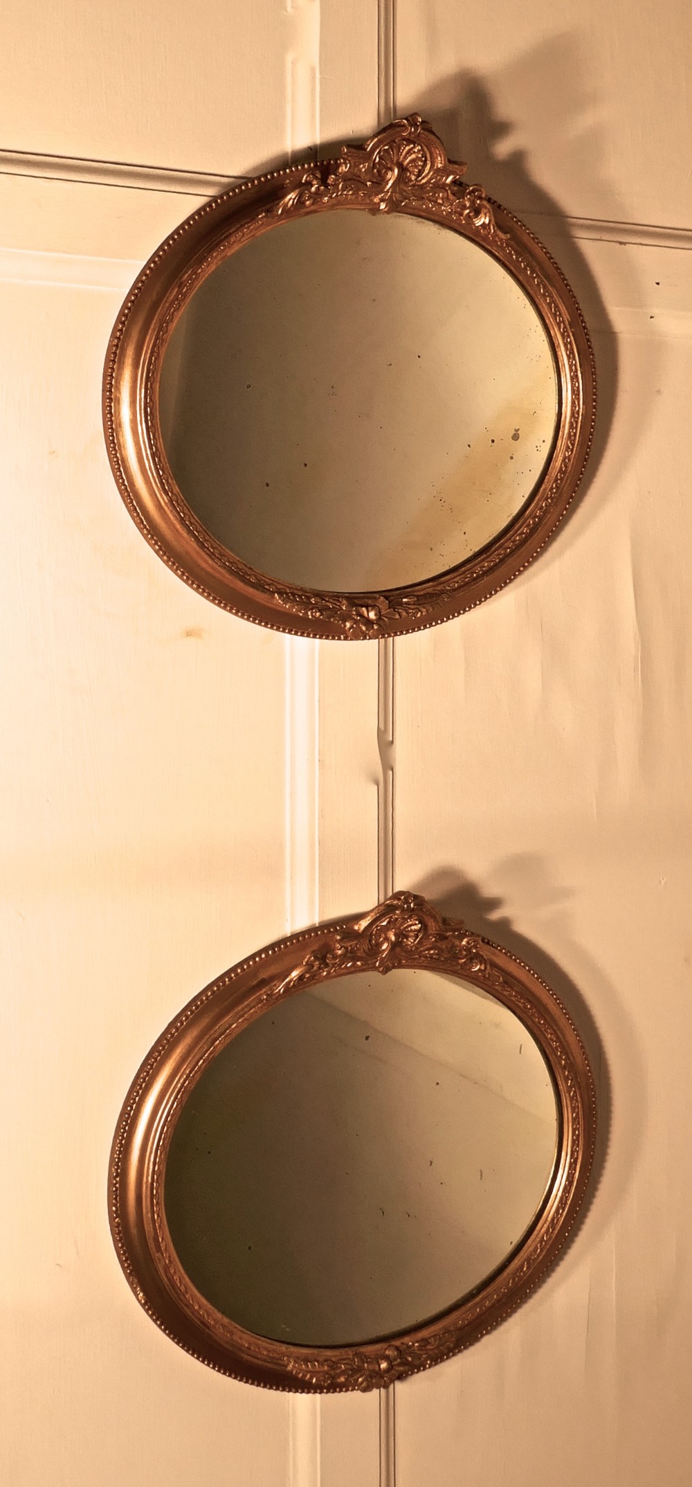 A Rare Pair of 19th Century Regency Style Oval Gilt Mirrors