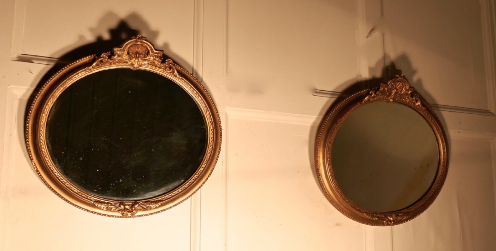 A Rare Pair of 19th Century Regency Style Oval Gilt Mirrors View IV