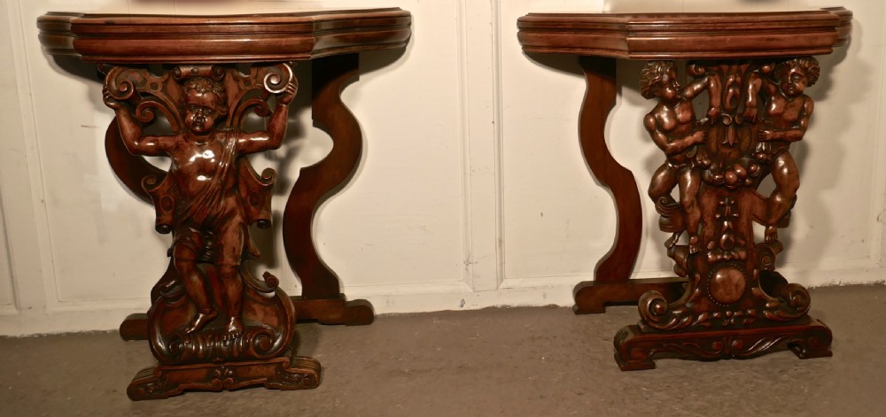 A pair of 19th Century Ornately Carved Walnut Rocco Console Tables 