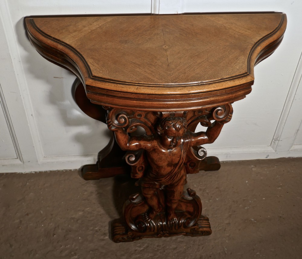 A pair of 19th Century Ornately Carved Walnut Rocco Console Tables  View III