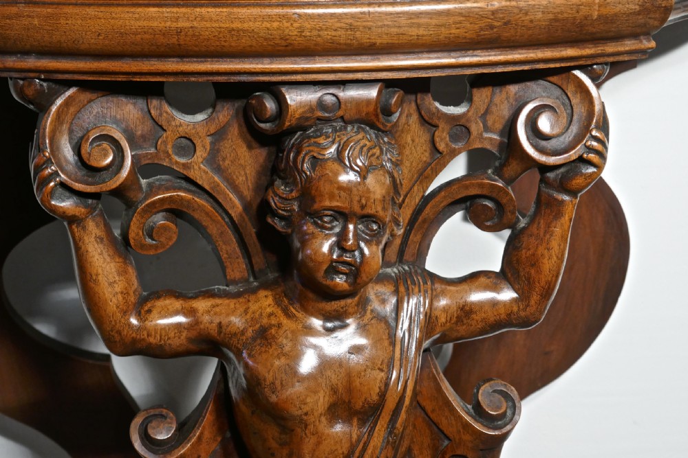 A pair of 19th Century Ornately Carved Walnut Rocco Console Tables  View IX