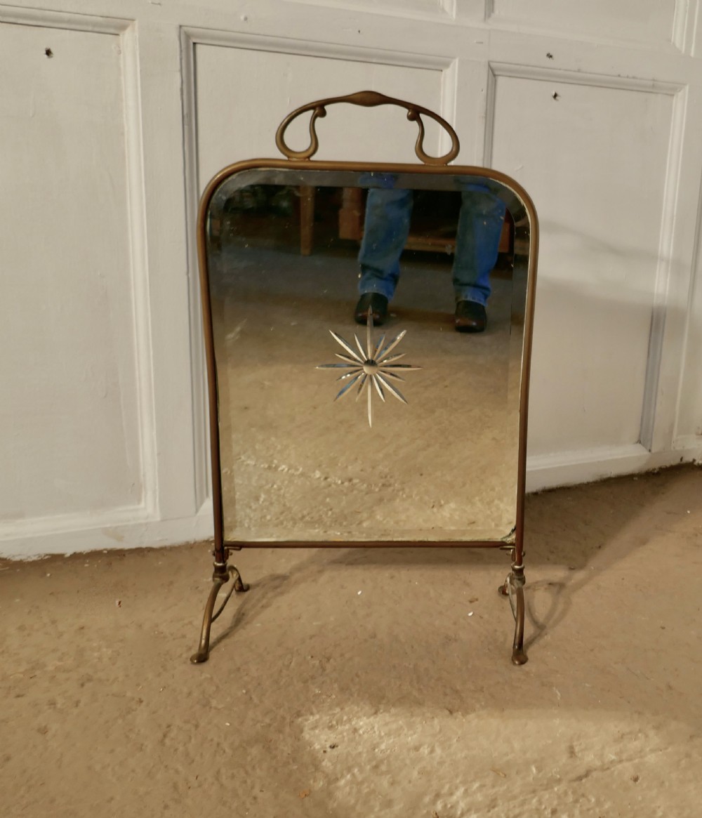 A Victorian Art Nouveau Brass and Sunburst Mirror Fire Screen