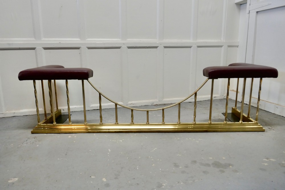 A Superb Large Brass and Leather Club Fender