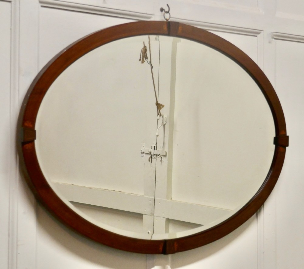 A Large Edwardian Inlaid Mahogany Oval Mirror