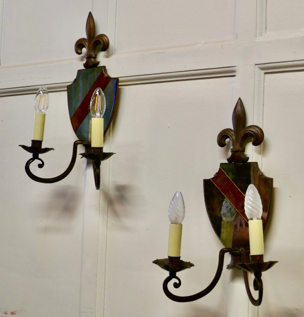 A Pair of Wrought Iron Heraldic Shield Shaped Girandole Wall Mirrors