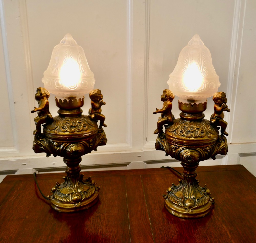 A Pair of  19th Century French Gilt Lamps in the form of Cherubs or Putti  