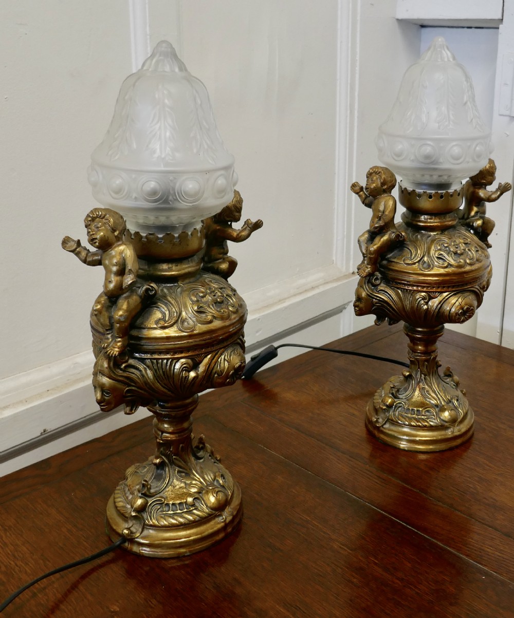 A Pair of  19th Century French Gilt Lamps in the form of Cherubs or Putti   View II