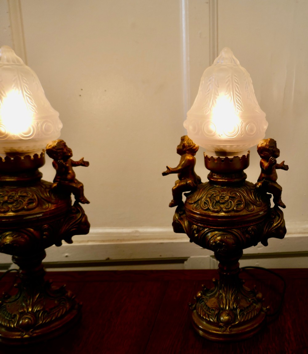 A Pair of  19th Century French Gilt Lamps in the form of Cherubs or Putti   View V