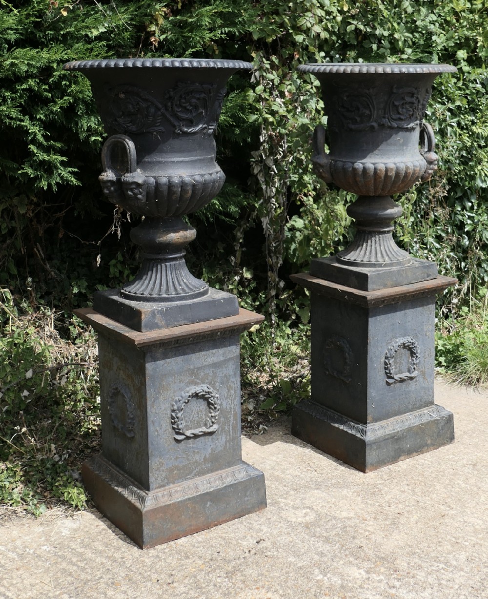 A Pair of Large Cast Iron Urns, Garden Planters on Plinths