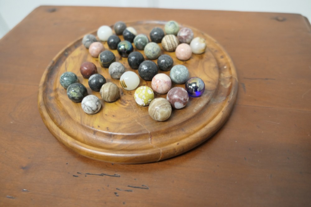 A set of French Marbles on a Turned Solitaire Board View II