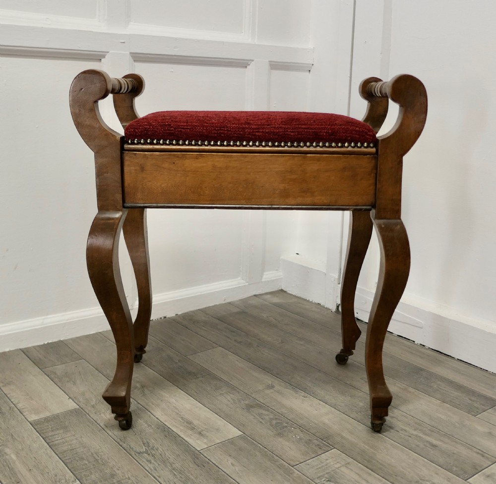 An Edwardian Walnut Piano Stool