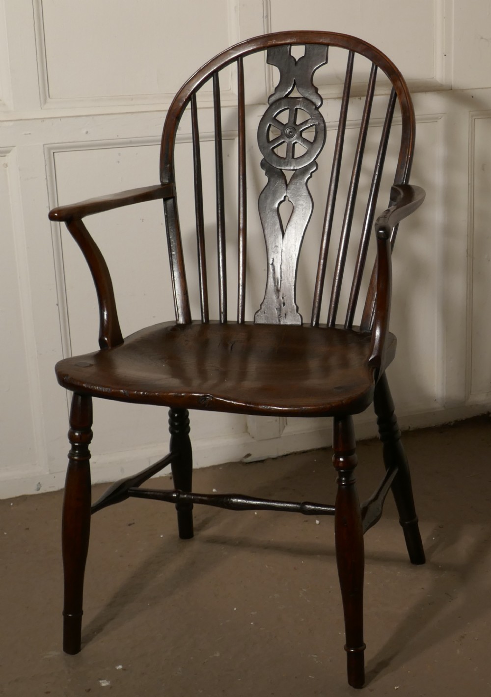 An Early 19th Elm Wheel Back Carver Chair