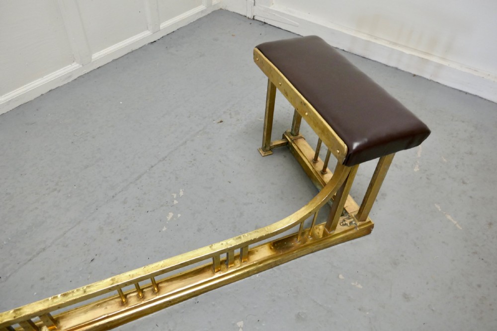 A Large Brass and Leather Club Fender View VII