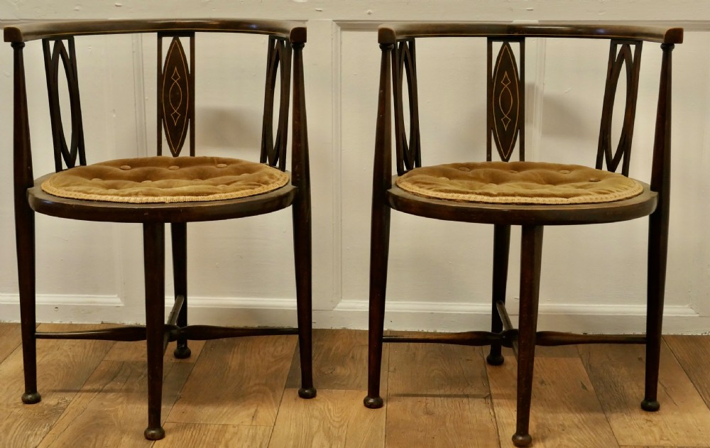 A pair of Edwardian Circular Arm Chairs