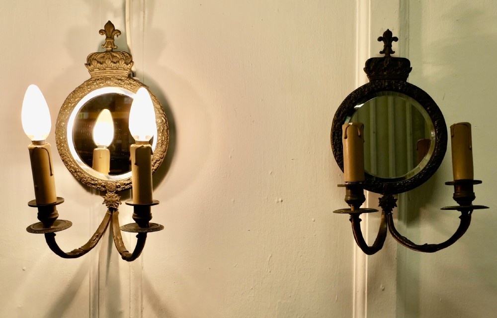 A Pair of Round Brass Girandole Wall Mirrors, in a Regal Design