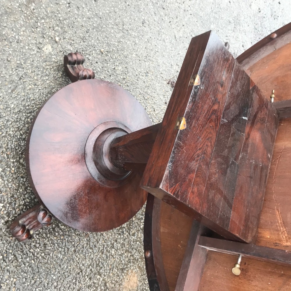 An early Victorian circular rosewood breakfast table featuring a figured timber top on a central pedestal base with carved feet. View VIII