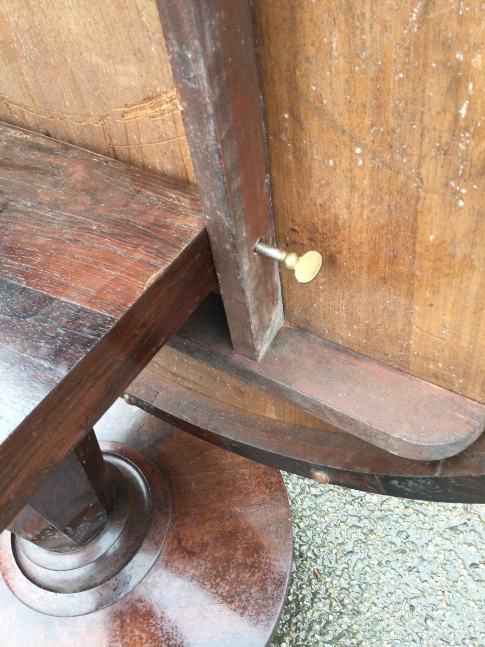 An early Victorian circular rosewood breakfast table featuring a figured timber top on a central pedestal base with carved feet. View X